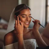 Makeup artist applying bridal makeup